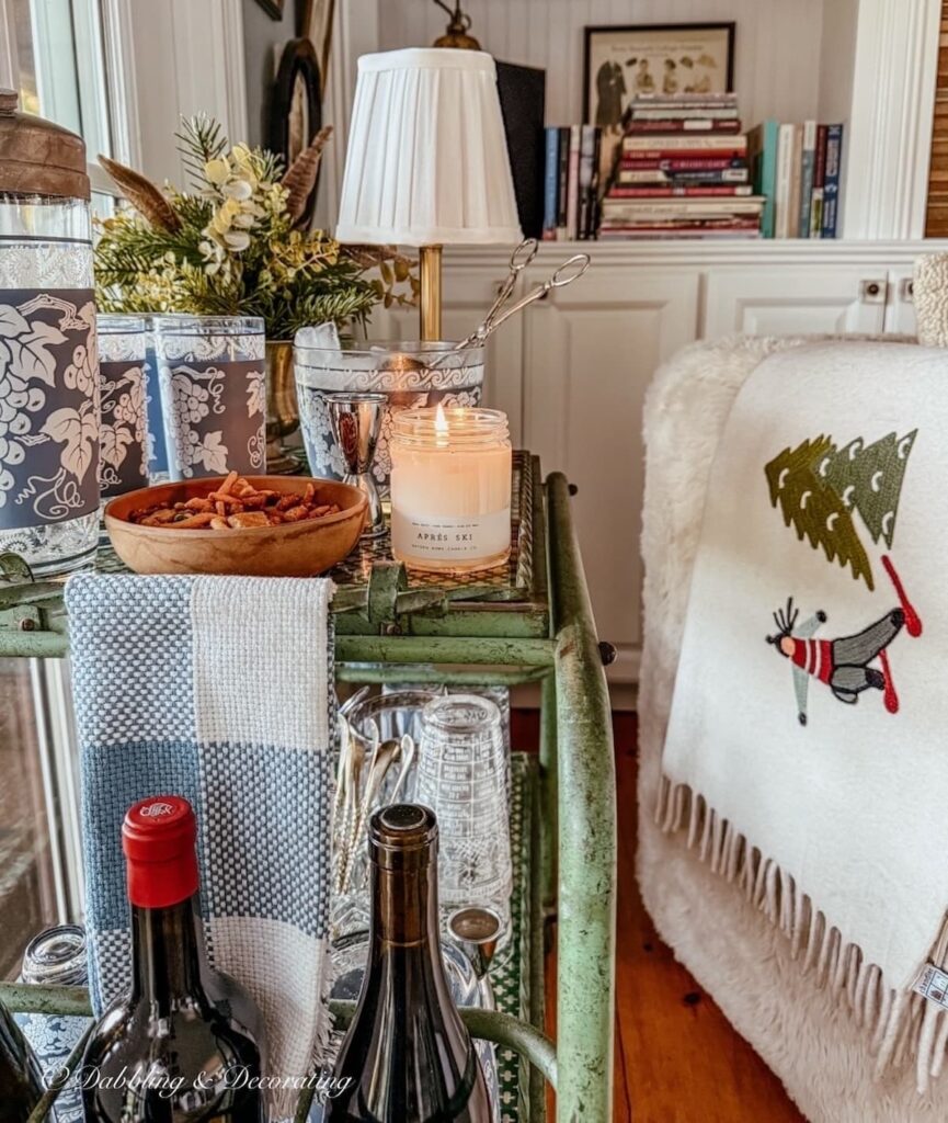 Vintage bar cart styled for Après-Ski with Vermont candles burning and vintage Jeannette barware in cozy living room corner.