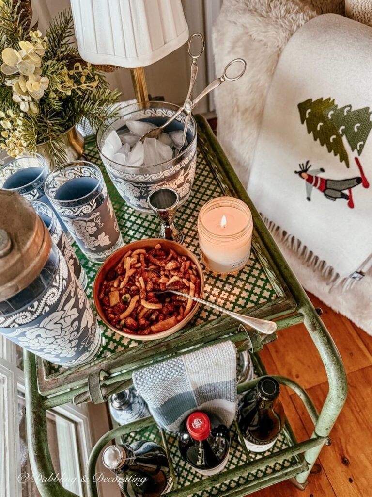 Antique bar cart styled with a vintage Jeannette cocktail set, wine, and Après-Ski Vermont candles from Hayden Rowe Candles.