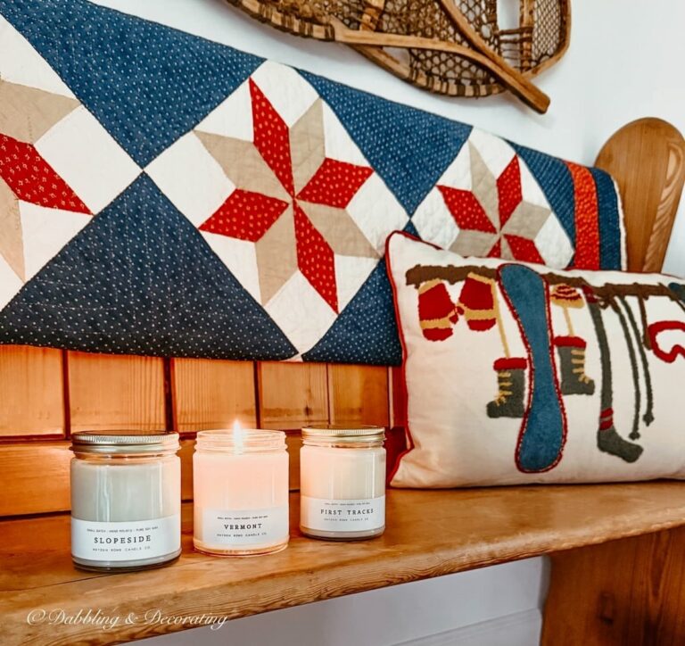 3 Hayden Rowe Candes; Vermont, First Tracks, and Slopeside scents on a vintage church pew accessorized with vintage quilt, ski lodge pillow and vintage snowshoes in entryway.